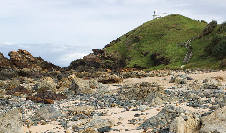Rocky coastline with a distant lighthouse, Sea Acres  National Park. Photo: Rob Cleary