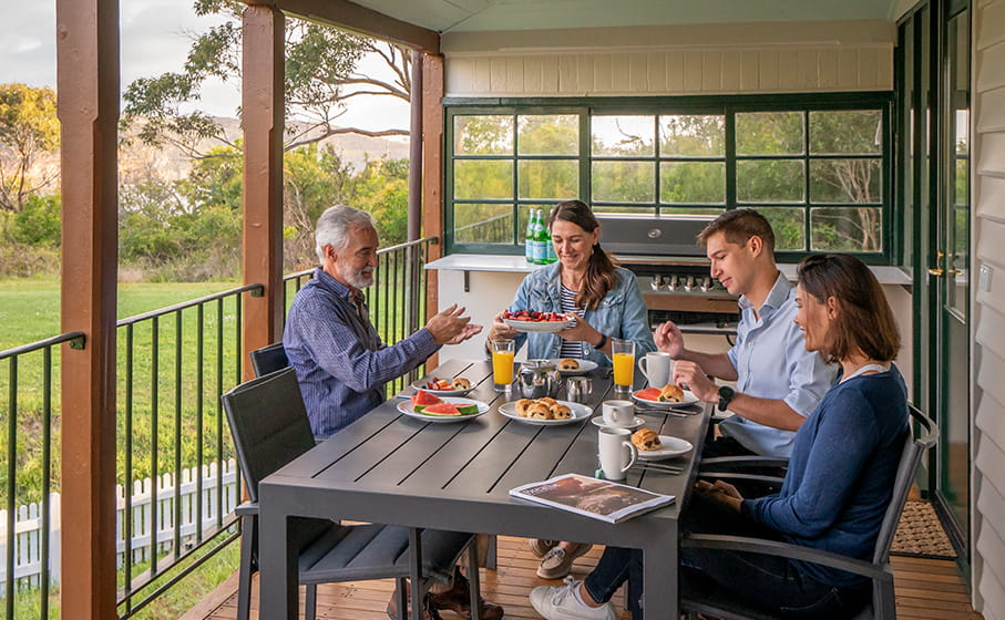 A group enjoying breakfast at Middle Head Officers Quarters accommodation in Sydney Harbour National Park. Credit: John Spencer &copy; DCCEEW