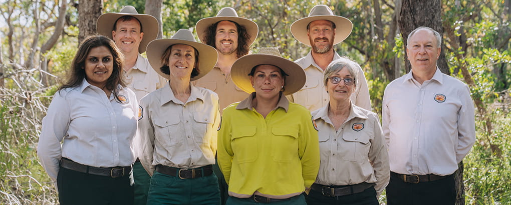 NPWS staff members in uniform with trees in the background. Credit: Remy Brand &copy; DPE