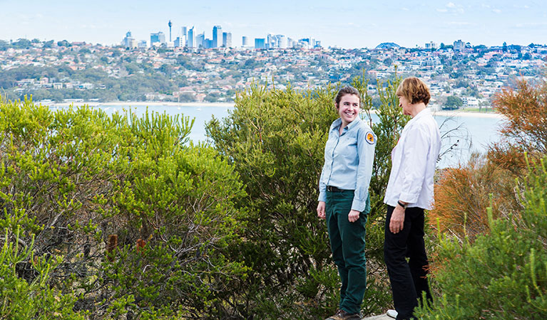 A park visitor and field officer on Manly scenic walkway at Dobroyd Head, Sydney Harbour National Park. Photo: Simone Cottrell/DPIE
