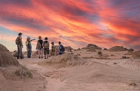 An Aboriginal ranger hosting a tour of the Mungo lunette rock formations at sunset in Mungo National Park. Credit: Aaron Davenport &copy; Aaron Davenport