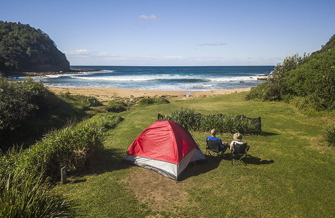 Aerial view of a red tent at Little Beach campground in Bouddi National Park. Photo credit: John Spencer &copy; DPIE