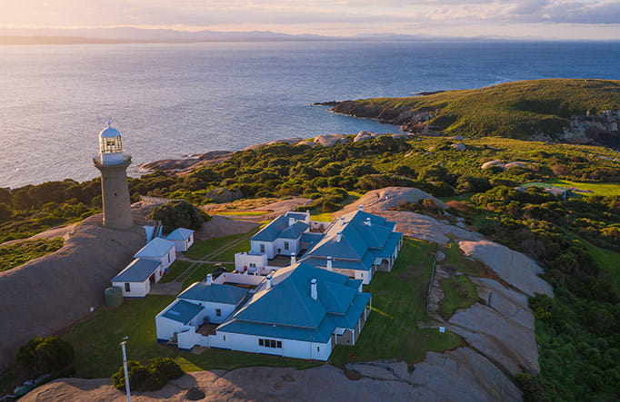 Aerial view of Montague Island lighthouse and cottages at sunset, Montague Island Nature Reserve. Photo: Daniel Tran/DPIE