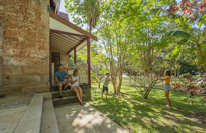 A family outside Gardeners Cottage in Sydney Harbour National Park. Photo credit: John Spencer © DPIE