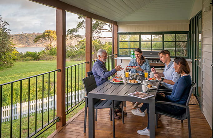 People dining on the verandah at Middle Head Officers Quarters, Sydney Harbour National Park. Photo credit: John Spencer &copy; DPIE