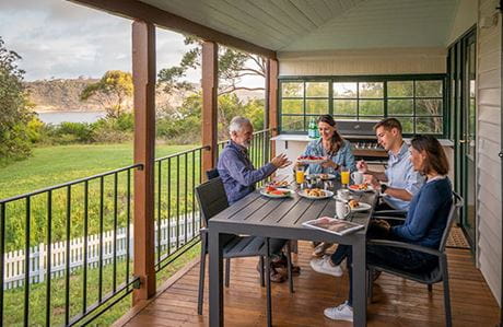 People dining on the verandah at Middle Head Officers Quarters, Sydney Harbour National Park. Photo credit: John Spencer &copy; DPIE