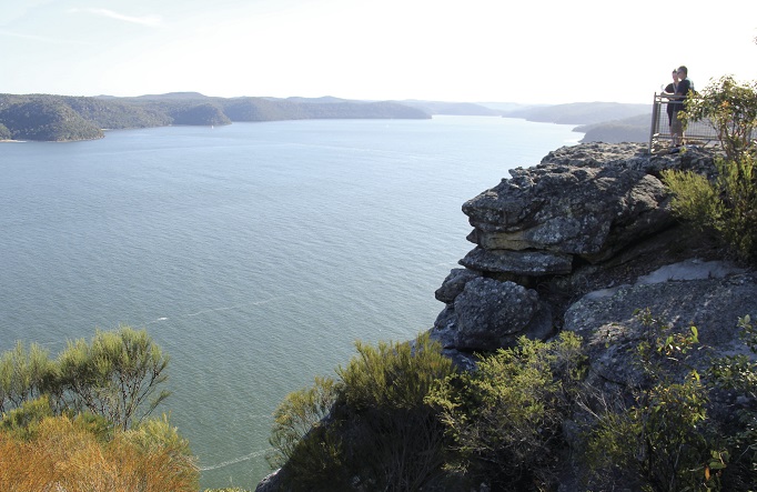 Two people admire the view at Warrah lookout, Brisbane Water National Park. Photo: John Yurasek/OEH
