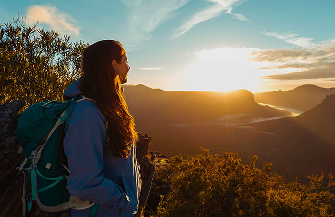 A young woman watches a dramatic sunset over the Blue Mountains. Photo credit: Andy Lloyd copy; Women Want Adventure