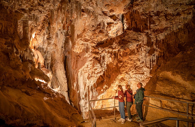 Three people admire limestone formations in Fig Tree Cave at Wombeyan Karst Conservation Reserve. Photo: John Spencer/DPIE