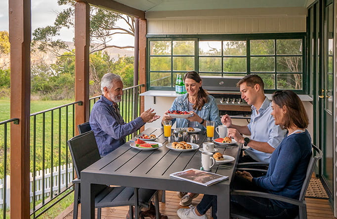 A group enjoying breakfast at Middle Head Officers Quarters accommodation in Sydney Harbour National Park. Credit: John Spencer &copy; DCCEEW