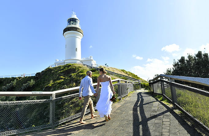 A couple walking up the path to Cape Byron lighthouse in Cape Byron State Conservation Area. Photo: Fiora Sacco &copy; DPIE