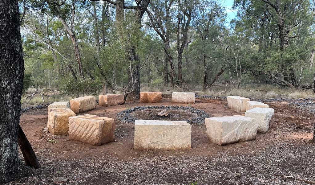 Sandstone blocks around a fire forming a yarning circle at Deriah Aboriginal area, joint managed by NPWS and the local Aboriginal community. Credit: DCCEEW &copy; DCCEEW.