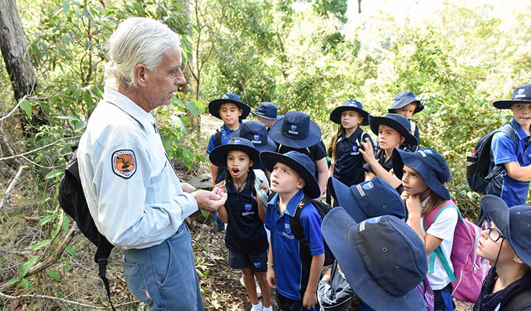 An Aboriginal guide with a group of students on an Aboriginal culture school excursion in Blue Gum HIlls Regional Park. Photo: Adam Hollingworth &copy; DPIE