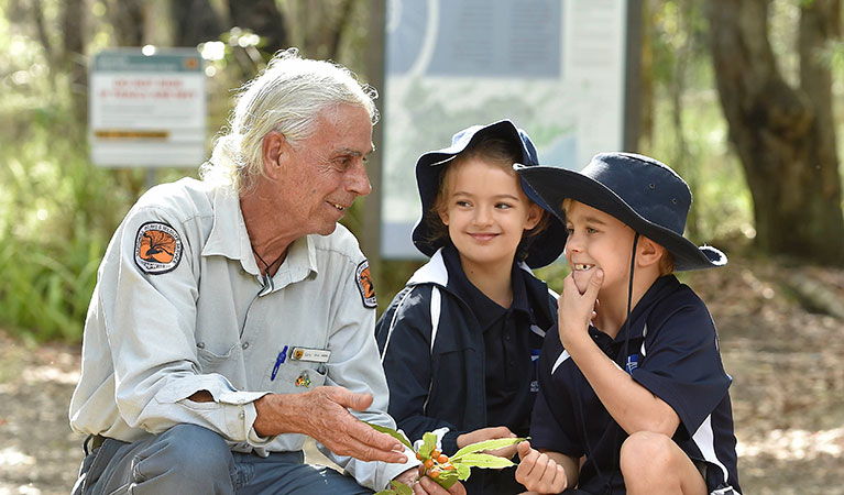 Students learning about Awabakal Country with an Aboriginal guide on a school excursion in Glenrock State Conservation Area. Photo: Adam Hollingworth &copy; DPIE