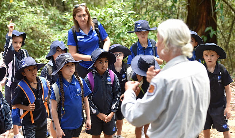 Students listening to an NPWS guide on a school excursion. Photo: Adam Hollingworth &copy; DPIE