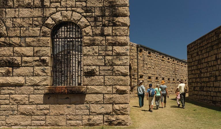 Image of a group touring the magnificent granite walls of Trial Bay Gaol