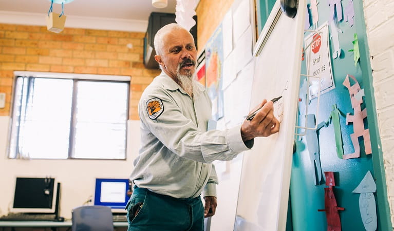 An Aboriginal NPWS educator leading an incursion at Coffs Harbour Christian Community School, 2019. Photo: Jay Black &copy; NPWS