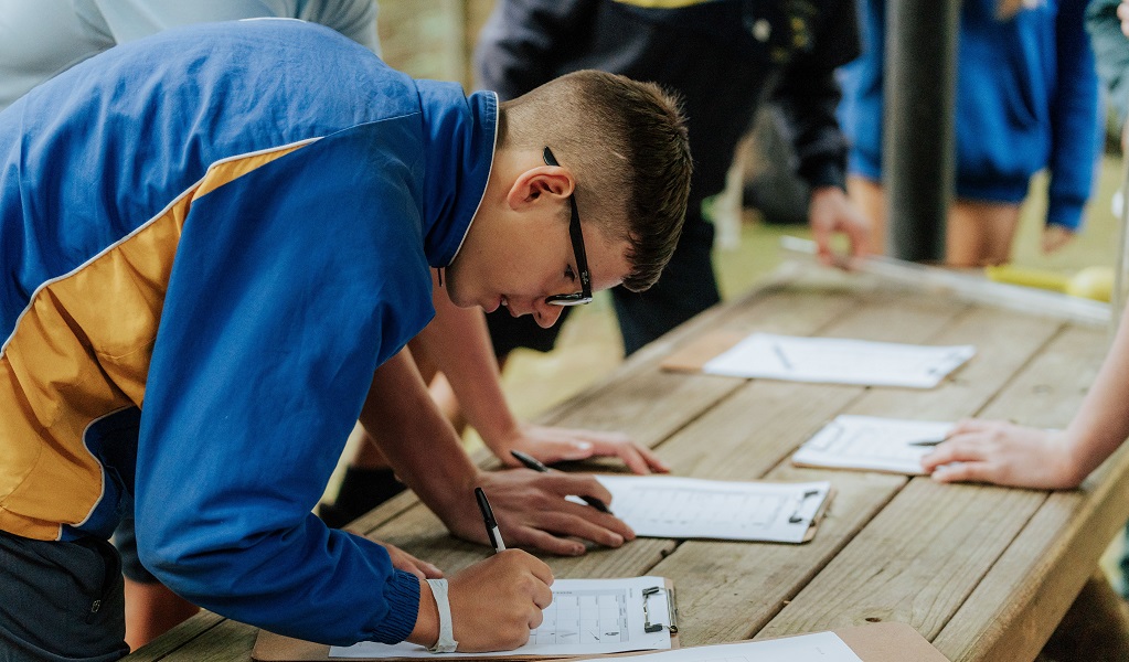 A student fills out a worksheet, Minnamurra Rainforest, Budderoo National Park. Photo: Remy Brand/DCCEEW &copy; DPE