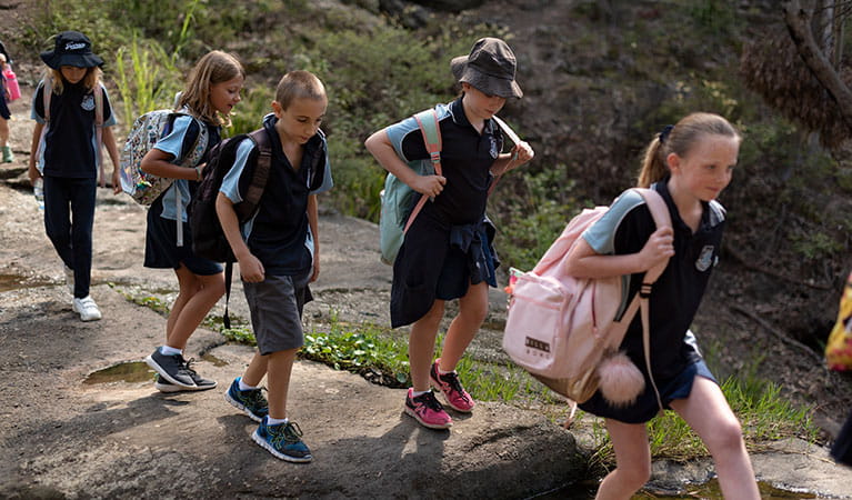 Students walking over rocks on a school excursion in Booti Booti National Park. Photo: Elana Clark &copy; DPIE
