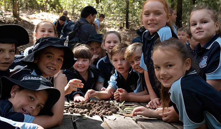 A group of students around a picnic table on a school excursion in Towarri National Park. Photo: Elana Clark &copy; DPIE