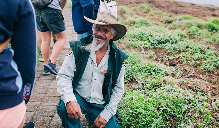 An NPWS guide speaking to students on The rookery roundabout school excursion in Muttonbird Island Nature Reserve. Photo: And the Trees Photography &copy; DPIE