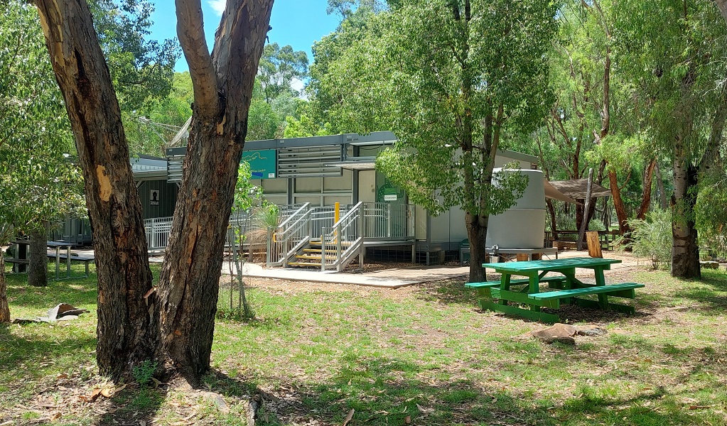 Exterior shot of Warrumbungle Environmental Education Centre, showing outside picnic tables and an entrance to the centre. Credit and &copy; Warrumbungle Environmental Education Centre 