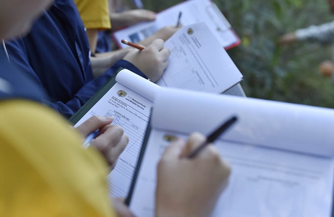 Students completing worksheets, Tomaree National Park, 2019. Photo: Adam Hollingworth: Hired Gun &copy; DPIE 