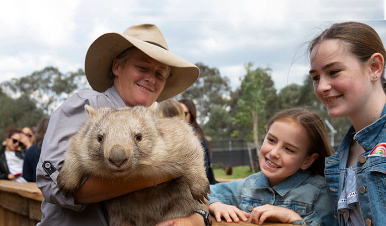 2 girls at Sydney Zoo with a zookeeper and wombat. Photo: &copy; AAT Kings