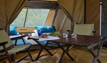 A tent equipped with comfortable mattresses and a table and chairs on a Bower Camp Co. retreat. Credit: Phil Gallagher &copy; Bower Camp Co.