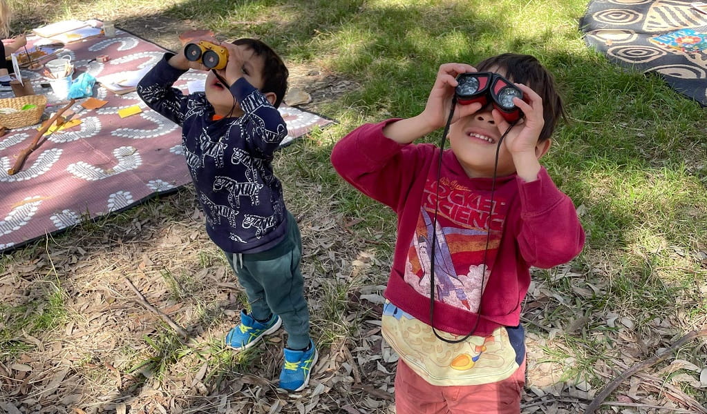 Kids looking through binoculars during a Bush Play School activity. Photo: Jodie Cooper &copy; Bush Play School