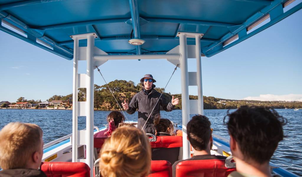 CoastXP tour guide on boat on Lake Macquarie. Photo &copy; CoastXP