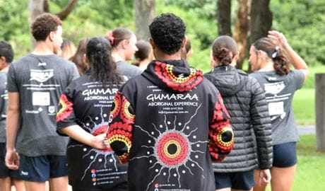 Group of people wearing Gumaraa logo clothing walking shot from behind. Photo &copy; Gumaraa