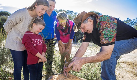 Guringai Tours' Laurie Bimson with a family group of tour guests on an Aboriginal cultural tour.  Photo &copy; Guringai Tours