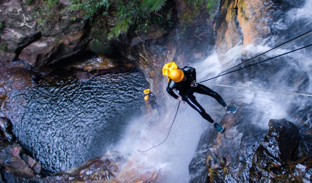 A person abseils down a waterfall in Empress Canyon on a guided tour with High and Wild in Blue Mountains National Park. Photo: Neil Aldred &copy; High and Wild