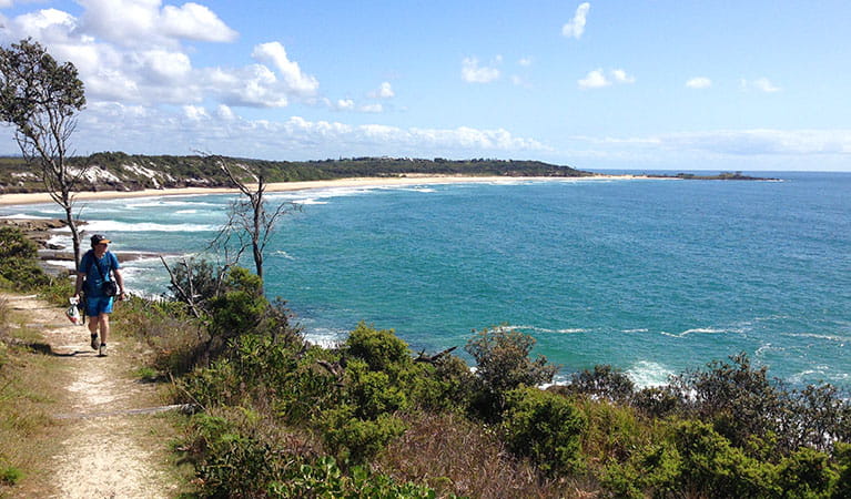 A hiker walks along a coastal track in Yuraygir National Park. Photo: Marcus Ludriks &copy; Home Comforts Hiking