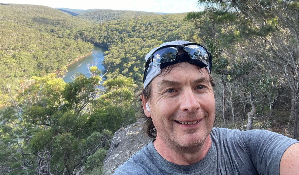 A selfie of a Journey2Ultra trail running guide with a river and bushland in the background in Royal National Park. Photo: Ash Daniels &copy; Journey2Ultra