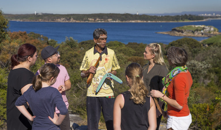Tour group watching demonstration by Tim Ella at La Perouse in Kamay Botany National Park. Photo: Dallas Kilponen