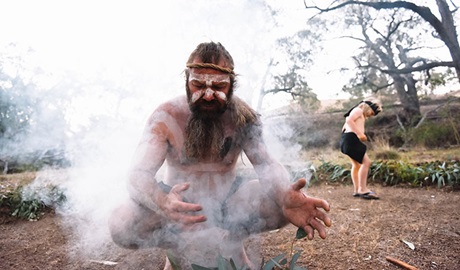 A Wiradjuri Person conducting a spiritual smoking ceremony. Photo: Isabella Moore &copy; Milan Dhiiyaan