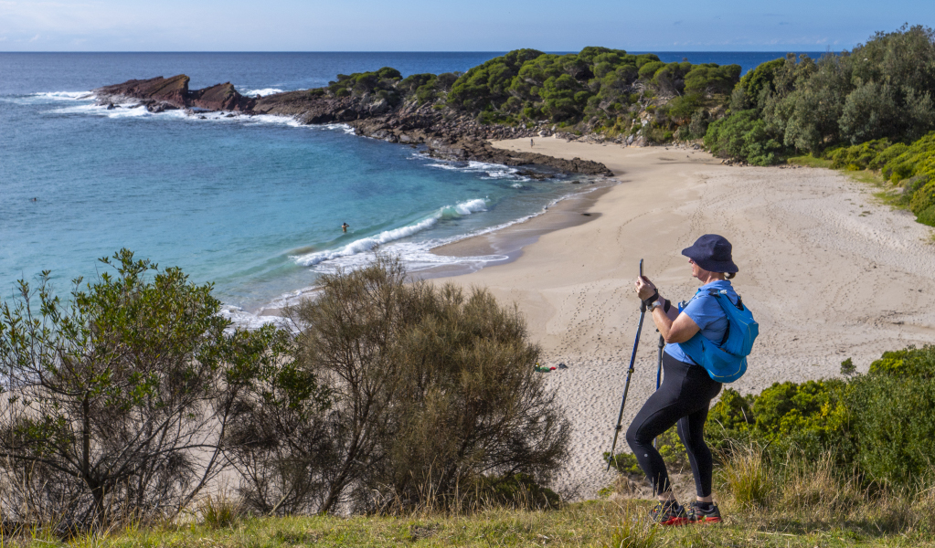 Woman in hiking gear taking photo of view of beach in Beowa National Park. Photo: &copy; Jessica Taunton