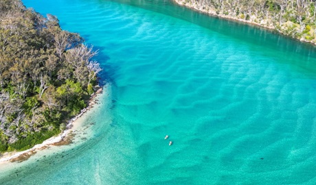 Arial photo of kayakers in aqua blue river. Photo &copy; Jessica Taunton