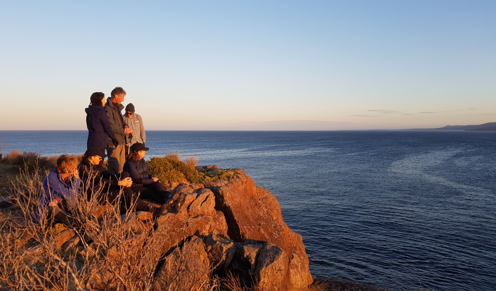 Group of people on cliff edge looking over the ocean in Beowa National Park. Photo: &copy; Park Trek Walking Holidays