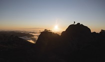 Hiker enjoying a sunset in Kosciuszko National Park. Photo: Tourism Snowy Mountains