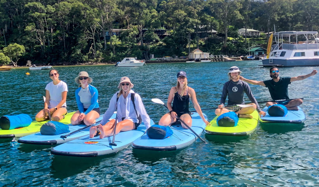Group of people on stand up paddle boards in Ku-ring-gai Chase National Park. Photo: Katie Brady &copy; Pittwater Eco Adventures.