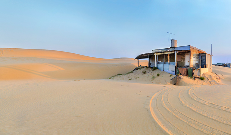 A Tin City shack set in the pristine landscape of Stockton sand dunes, in the Worimi Conservation Lands near Port Stephens. Photo © Andrea Drury