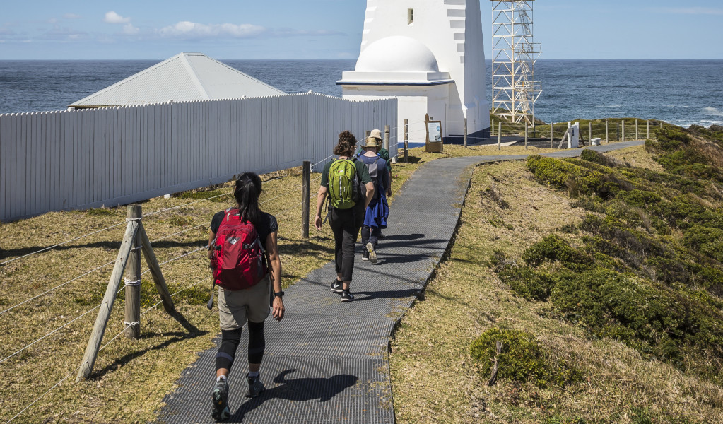 Walkers heading towards Green Cape Lighthouse, Green Cape in Beowa National Park.Photo: Destination NSW &copy; Destination NSW