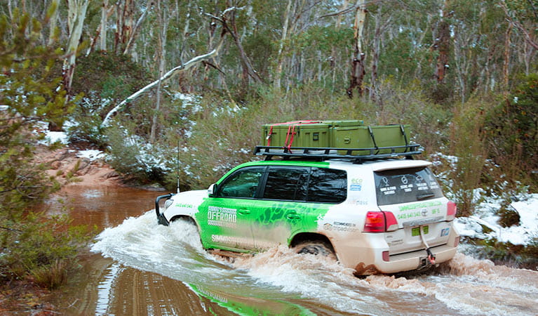 A 4WD vehicle makes a river crossing in bushland. Photo credit: Greg Simpson &copy; Simmo's Offroad Tours