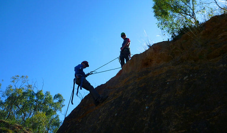 Silhouetted climbers with ropes on a rocky slope. Photo credit: Chris Brown &copy; Snowy Mountains Climbing School