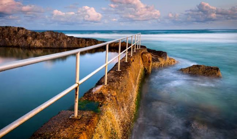 Twilight view of an ocean pool located along a rocky reef. Photo © Solitary Islands Coastal Walking Tours