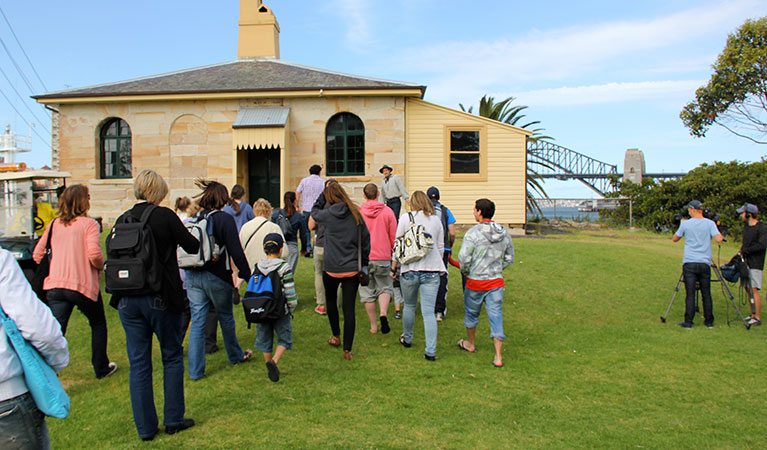 A group of people on a Sydney Harbour Tall Ships guided tour, with the Sydney Harbour Bridge in the background. Photo: &copy; Sydney Harbour Tall Ships