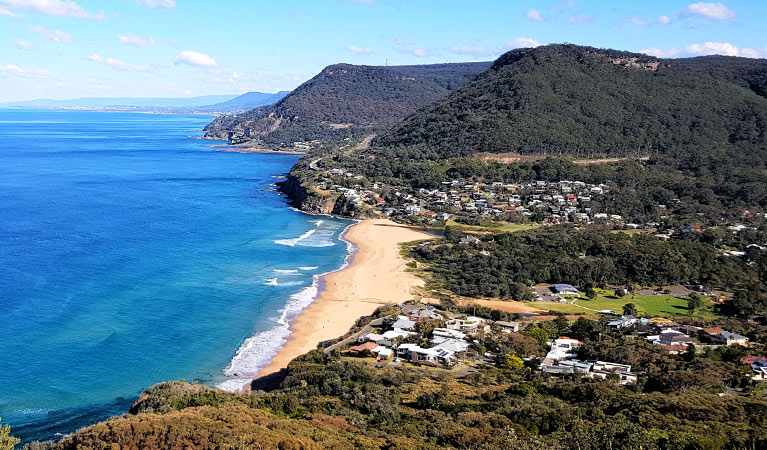 Sweeping view of coastline showing a sandy beach, coastal villages and hills. Photo credit: Andrew Sorokin © Sydney Private Guided Tours